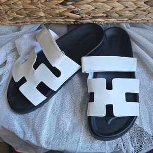 Hermès CHYPRE SANDAL - BLANC White and Black Slide Sandals